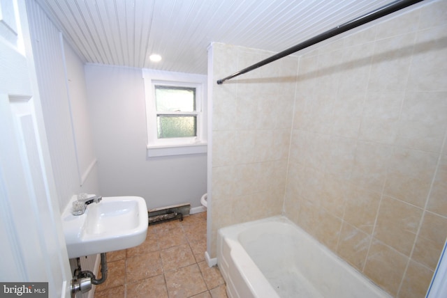 full bathroom featuring sink, tile patterned floors, toilet, and washtub / shower combination