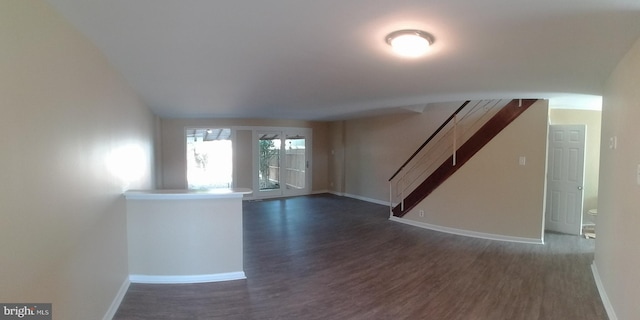 unfurnished room with dark wood-type flooring