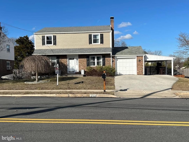 view of front of property with an attached garage, brick siding, fence, concrete driveway, and a chimney