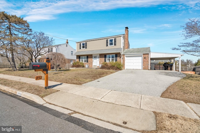 view of front of property with aphalt driveway, brick siding, a chimney, a garage, and an attached carport