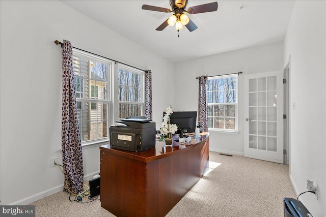 office space with a ceiling fan, carpet, and baseboards