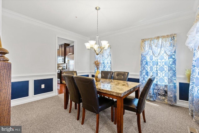 dining space with ornamental molding, visible vents, a chandelier, and light carpet