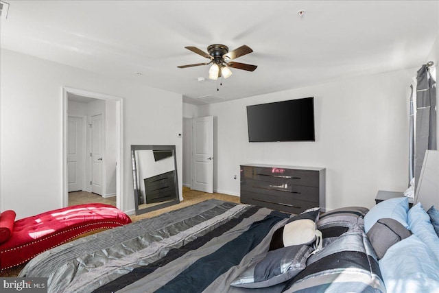 carpeted bedroom featuring visible vents, baseboards, and ceiling fan