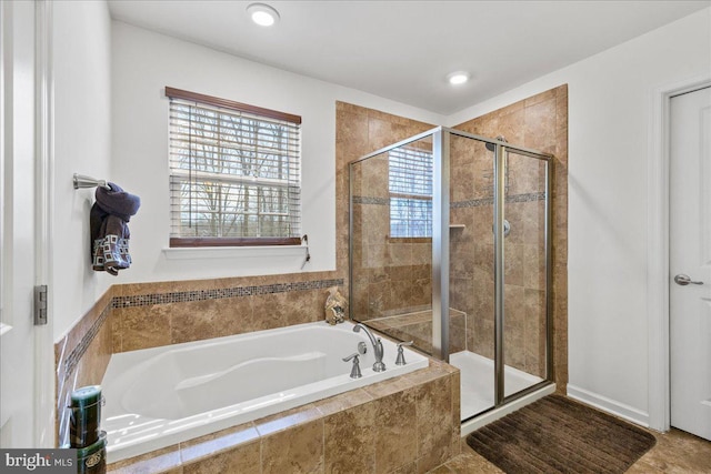 full bathroom with a shower stall, a bath, and recessed lighting