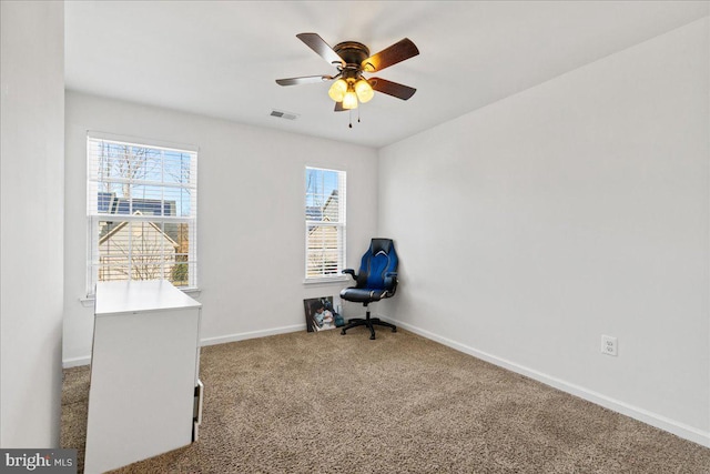 interior space with baseboards, visible vents, and ceiling fan