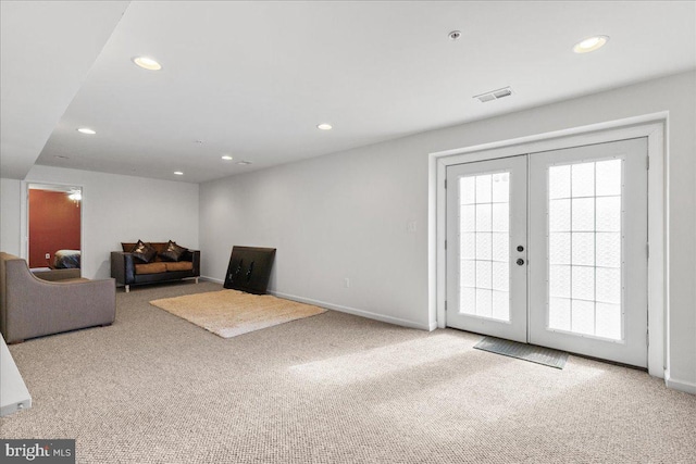 living area featuring recessed lighting, french doors, visible vents, and carpet floors