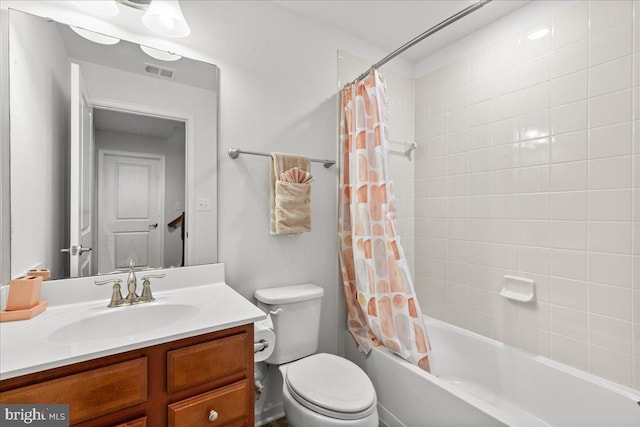 bathroom featuring visible vents, toilet, shower / bath combo, and vanity