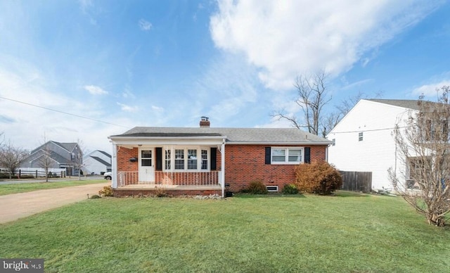 view of front of home with a front yard and covered porch