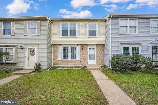 view of property featuring a front lawn