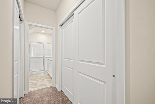 hallway with light colored carpet