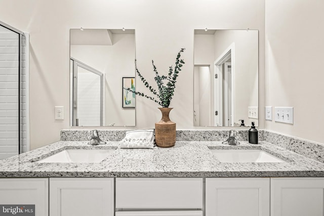 bathroom featuring an enclosed shower and vanity