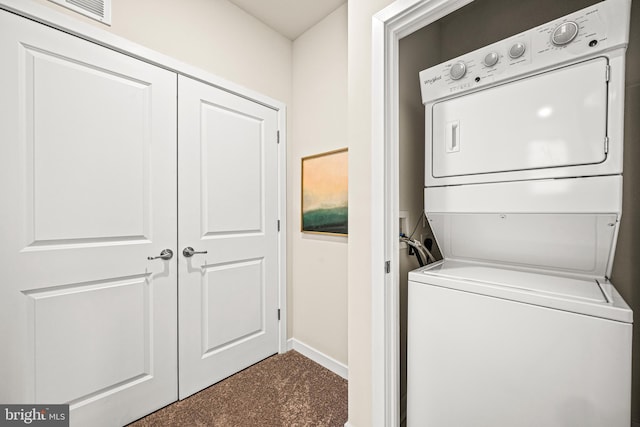 laundry area with stacked washer and dryer