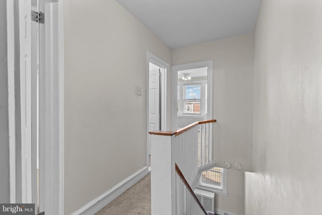 hallway with light colored carpet