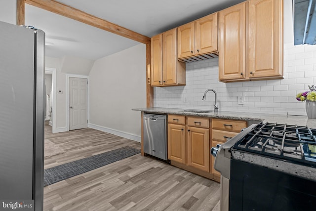 kitchen with sink, appliances with stainless steel finishes, light stone countertops, light brown cabinets, and light wood-type flooring