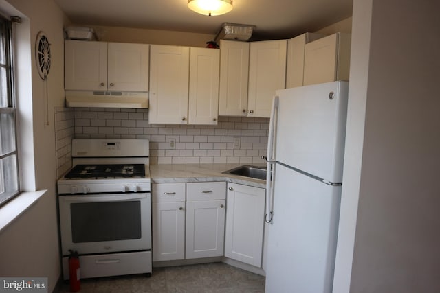 kitchen featuring white cabinetry, backsplash, and white appliances