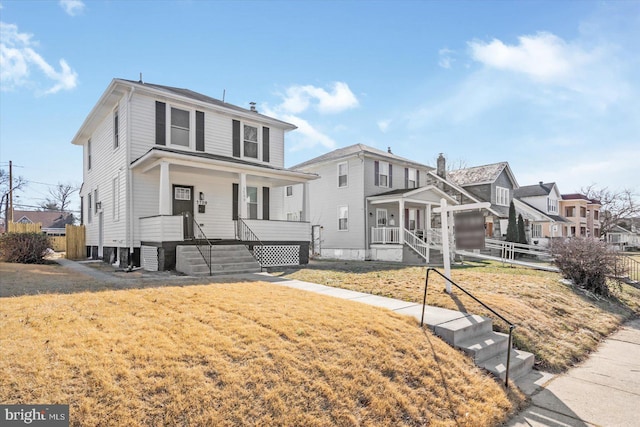 view of property with a front yard and a porch