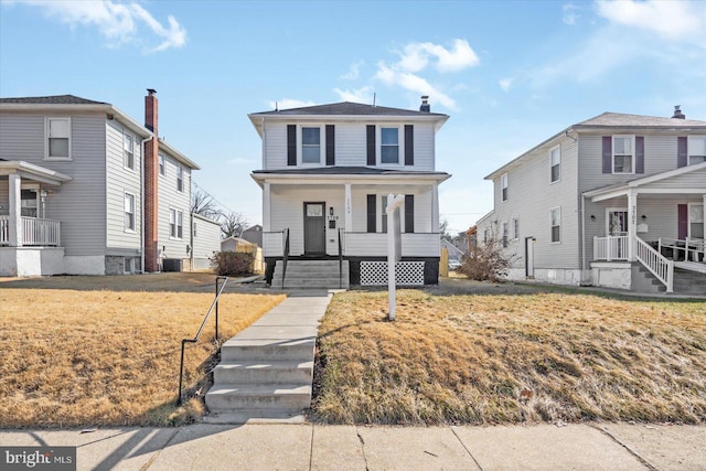 front of property featuring cooling unit, a front yard, and covered porch