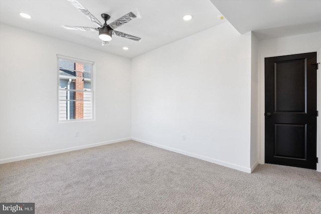 spare room with light carpet and ceiling fan