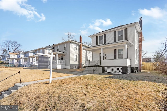 view of property with a front lawn and a porch