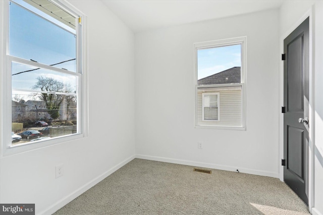 unfurnished room featuring carpet