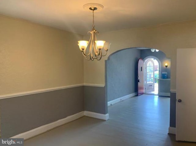 interior space with hardwood / wood-style floors and an inviting chandelier