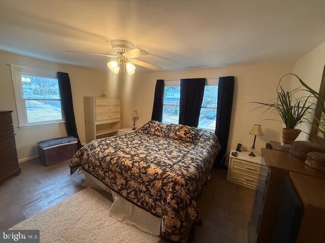 bedroom featuring multiple windows and ceiling fan