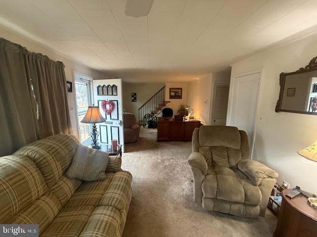 living room with stairway and carpet flooring