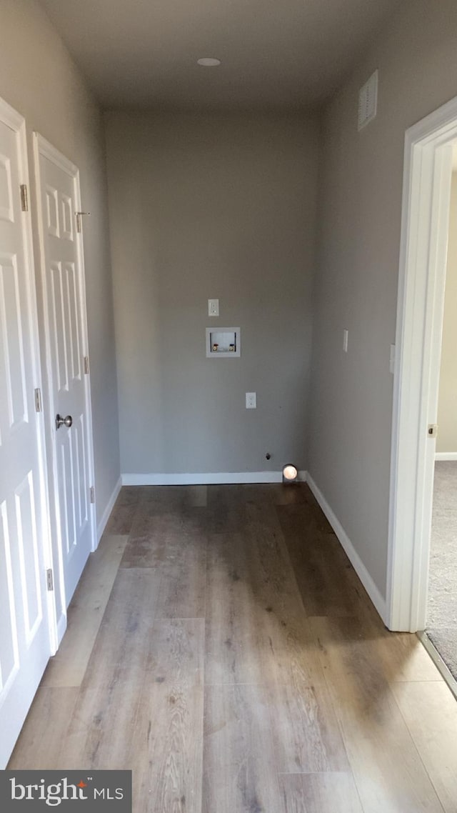 laundry area with washer hookup and light hardwood / wood-style flooring