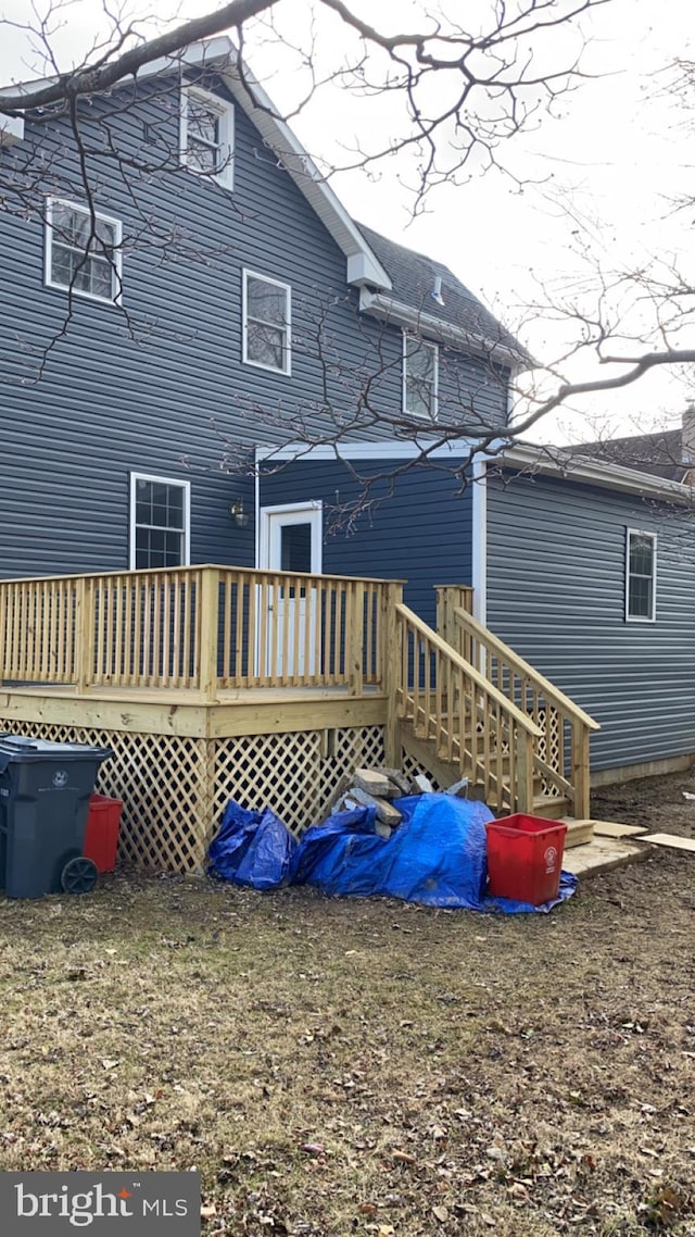 back of property featuring a deck