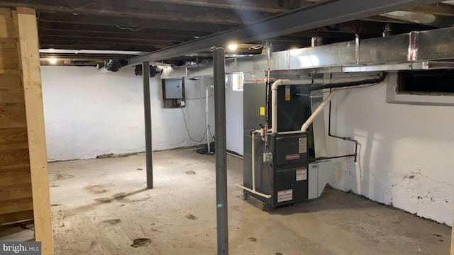 basement featuring heating unit and electric panel