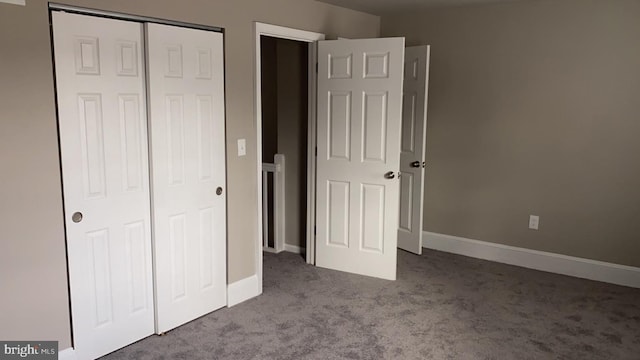 unfurnished bedroom featuring light colored carpet and a closet