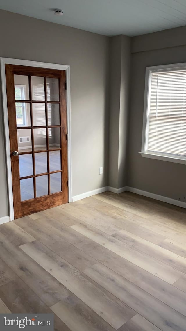 spare room featuring light hardwood / wood-style flooring