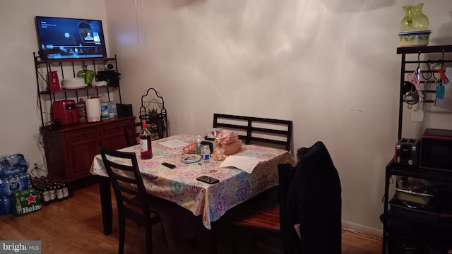 dining space with hardwood / wood-style flooring