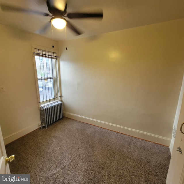 empty room featuring ceiling fan, radiator heating unit, and carpet floors