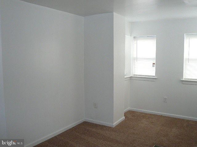 unfurnished room with carpet flooring