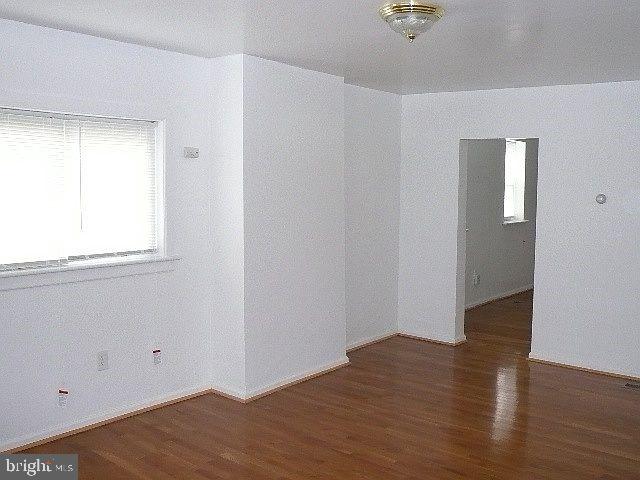 empty room with dark hardwood / wood-style floors