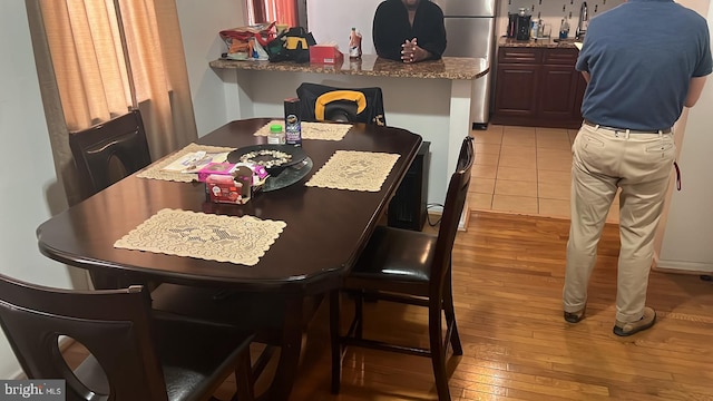 dining area featuring sink and light wood-type flooring