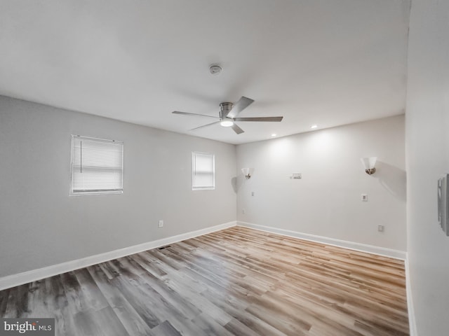 spare room with ceiling fan and light hardwood / wood-style flooring