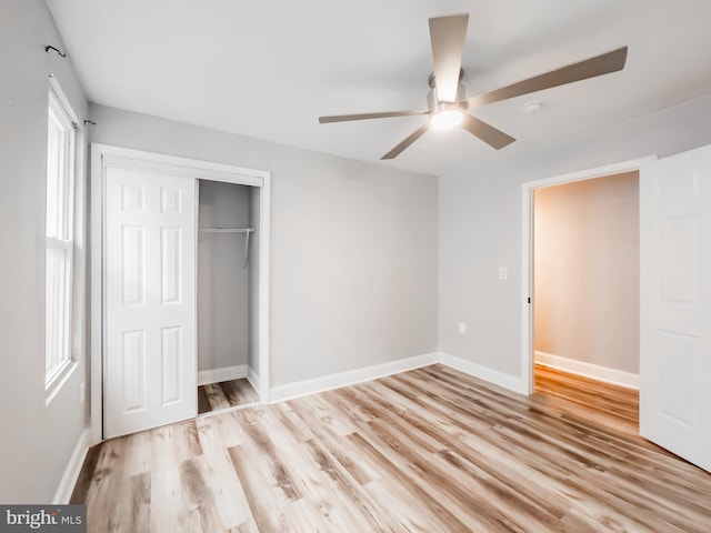 unfurnished bedroom featuring a closet, ceiling fan, and light wood-type flooring