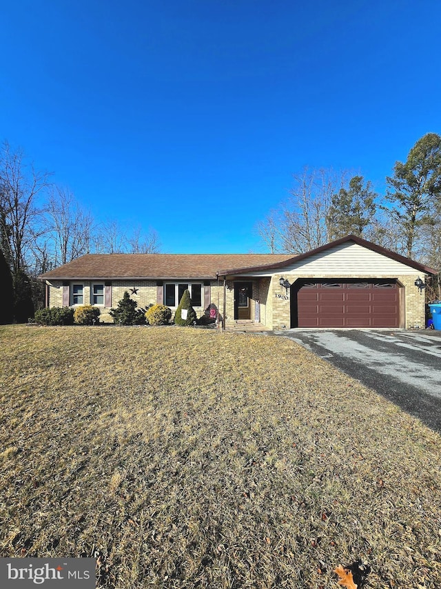 single story home with a garage and a front lawn