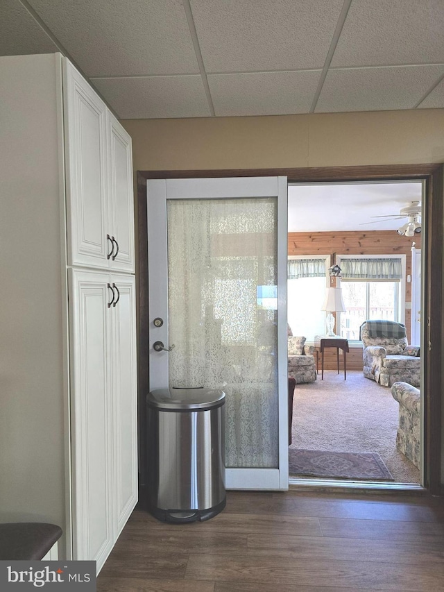 doorway to outside featuring dark hardwood / wood-style flooring and a paneled ceiling