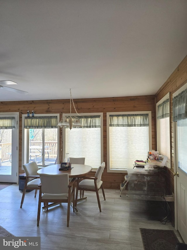 dining area featuring wood walls