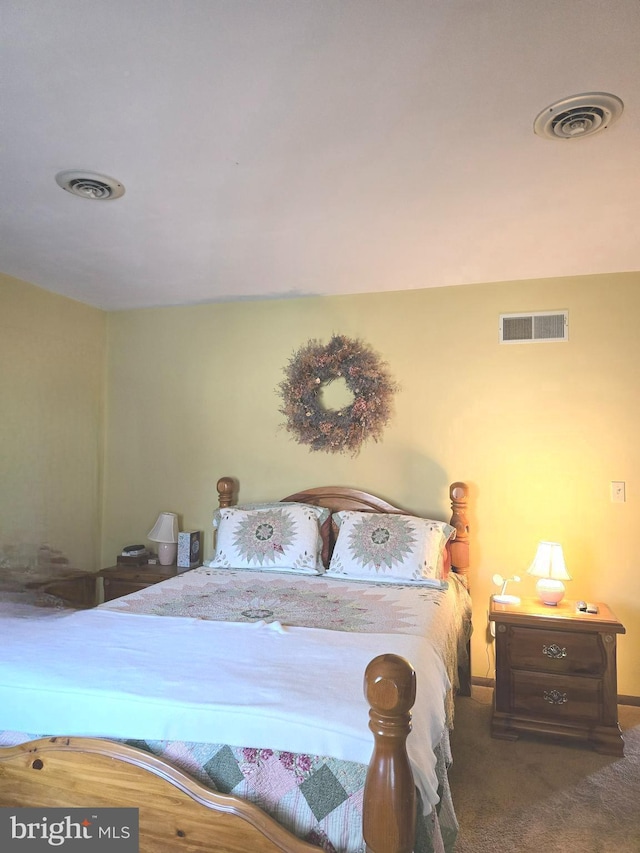 bedroom with dark colored carpet