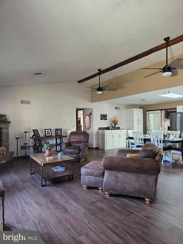 living room with lofted ceiling, a brick fireplace, dark wood-type flooring, and ceiling fan