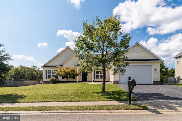 view of front of home with a garage and a front lawn