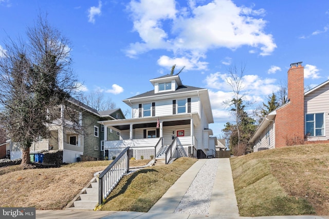 view of front of house with a front yard and covered porch