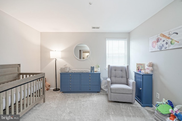 carpeted bedroom featuring a crib