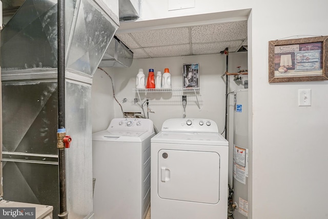 laundry room with gas water heater and separate washer and dryer