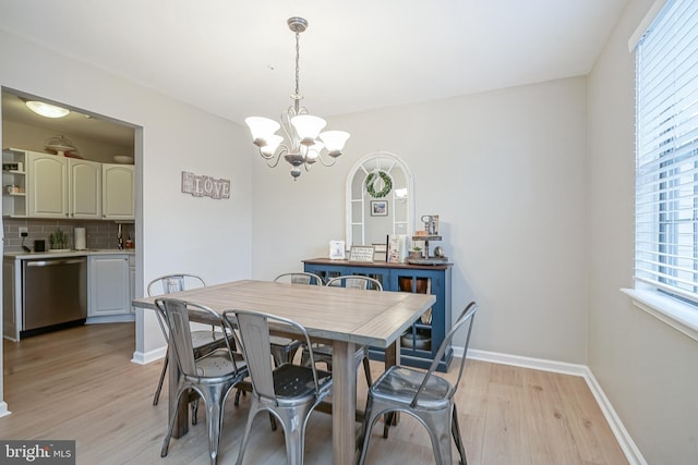 dining area with an inviting chandelier and light wood-type flooring