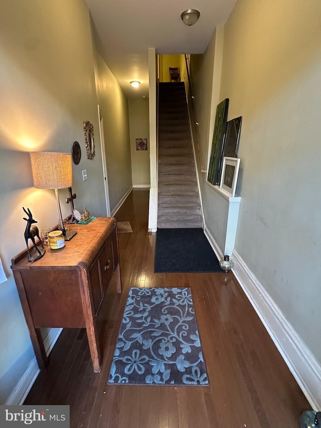 corridor with dark hardwood / wood-style flooring